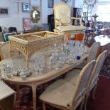 A contemporary wicker conservatory dining table and seven matching chairs and coffee table.