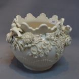 A Belleek Blanc De Chin jardiniere with floral and bird decoration (a/f).