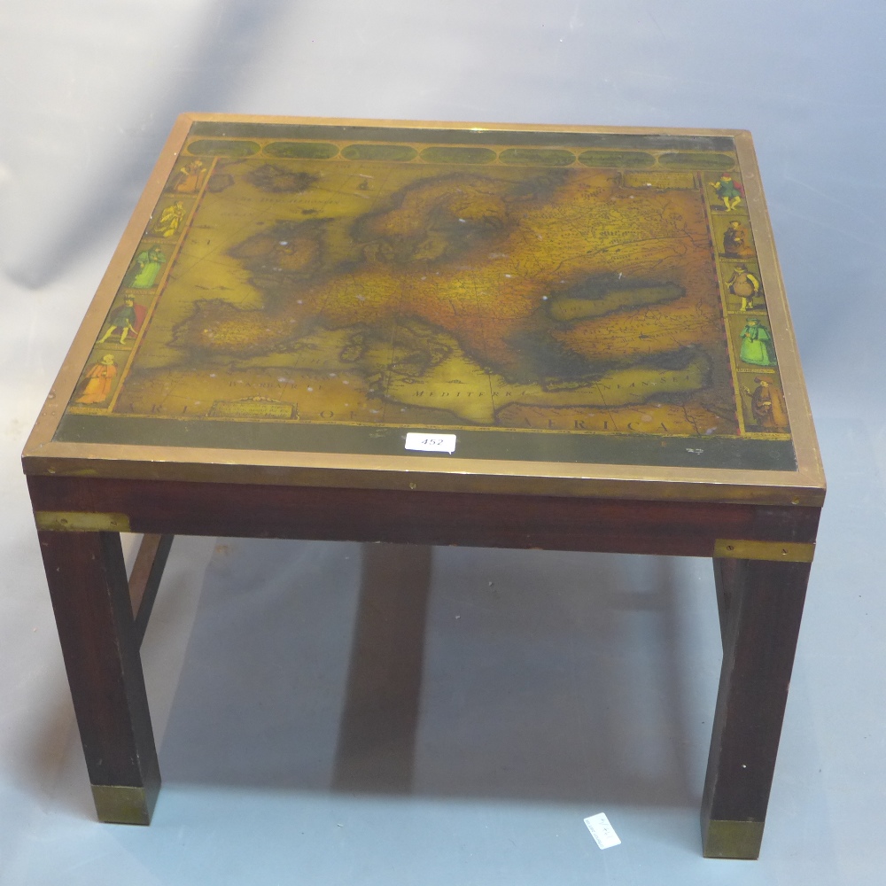 A campaign style mahogany coffee table with glass top depicting a 17th Century map of Europe.