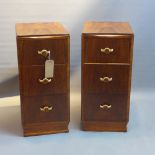 A pair of Art Deco walnut pedestal chests of three drawers, raised on plinth base.