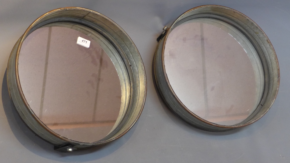 A pair of industrial circular mirrors.