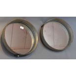 A pair of industrial circular mirrors.