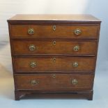 An early 19th Century oak chest of four graduating drawers raised on carved bracket feet.