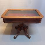 A William IV mahogany bijouterie table raised on reeded supports and castors.