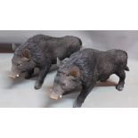 A pair of fibre glass models of boars.