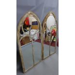 A pair of metal arch top garden mirrors.