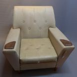 A 1950's white leather arm chair raised on tapered teak legs.