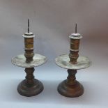 A pair of 19th Century bronze pricket sticks together with a pair of metal work candle sticks.