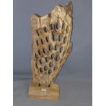 A contemporary carved wooden abstract sculpture.