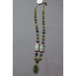 A ladies long Egyptian Jade and Nubian silver necklace having oval silver pendant inset with Jade.