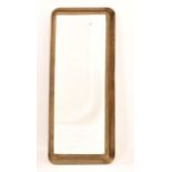 A contemporary wall mirror with a bronze frame