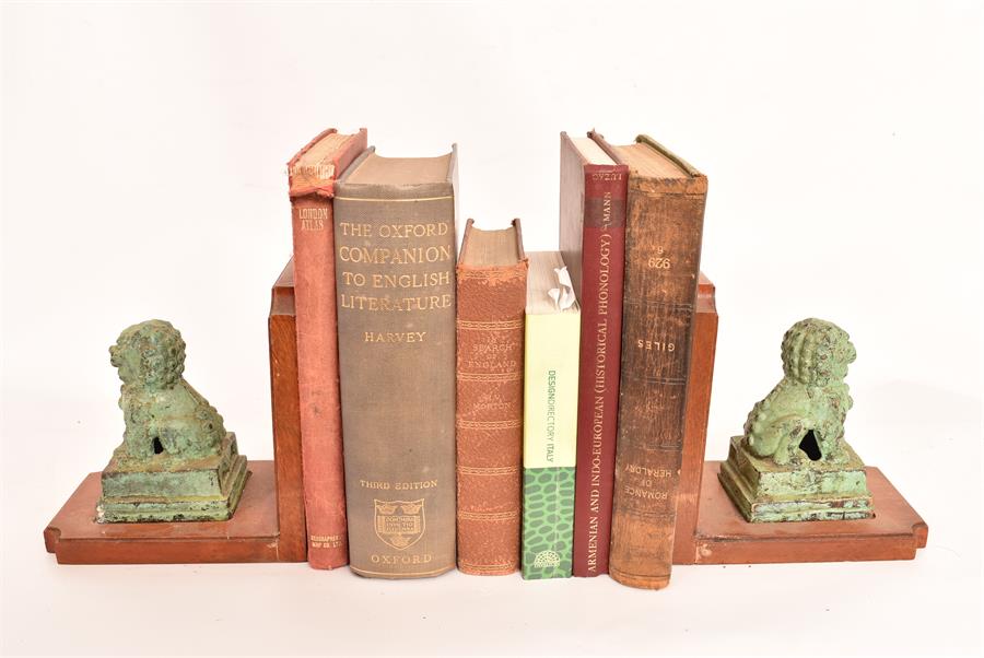 A pair of mahogany bookends with bronze Dogs of Fo decoration