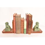 A pair of mahogany bookends with bronze Dogs of Fo decoration