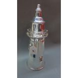 A silver plated cocktail shaker in the form of a lighthouse,