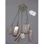 A silver chatelaine, with various silver pocket tools to include a sovereign case,