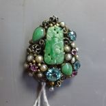 A vintage white metal brooch inset with central jade plaque having aquamarine rose quartz and seed