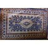 A Persian silk blue ground rug, signed,