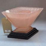 An Art Deco pink glass posy holder raised on base,