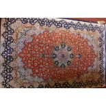 A Persian silk rug, signed,