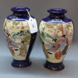 A pair of early 20th Century Japanese Satsuma vases decorated with figures in a courtyard cobalt
