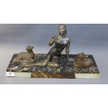 An Art Deco spelter study of a lady and sheep raised on marble base,
