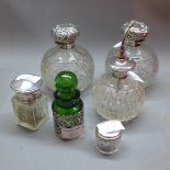 A pair of late Victorian silver topped and glass perfume bottles, Birmingham 1901,
