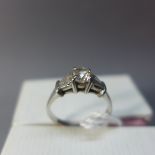An 18ct white gold engagement ring with 0.5ct solitaire flanked by four baguette diamonds approx 0.