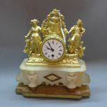 An early 20th Century French gilt metal mantle clock having alabaster base and raised on gilt wood