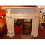 A large white painted pine fine surround with corinthium column supports,