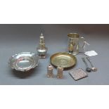 A collection of silver items to in include a small tanker, two dishes, two salt spoons,