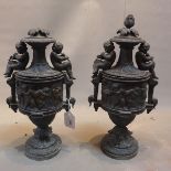 A pair of 19th Century cast bronze urns and covers decorated with putti.