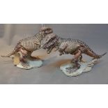 A pair of plaster models of a T-Rex.