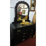 A 1930's ebonised French Gothic revival dressing chest with bevelled mirror plate above four