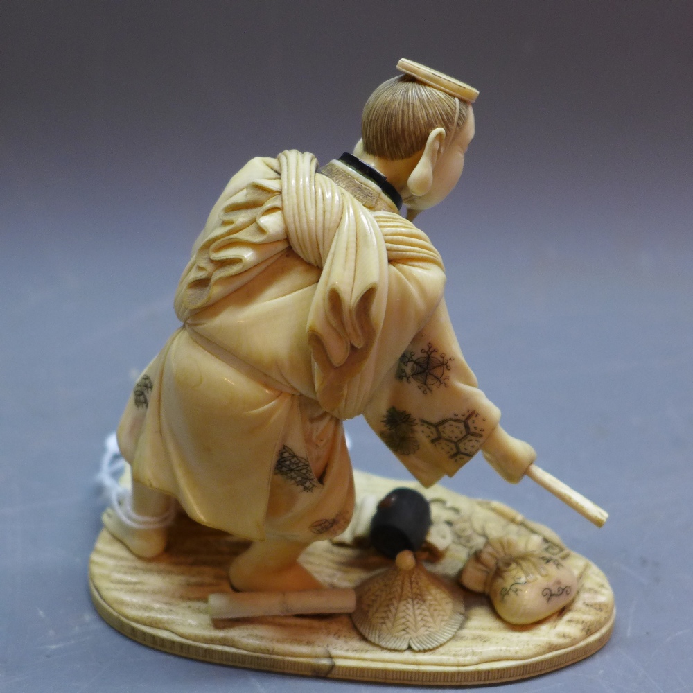 A 19th Century Japanese ivory carving of a fisherman, signed to base. - Image 2 of 4