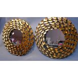 A pair of circular gilt metal mirrors