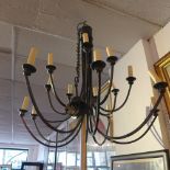 A Christopher Wray sixteen branch wrought iron chandelier.