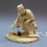 A 19th Century Japanese ivory carving of a fisherman, signed to base.