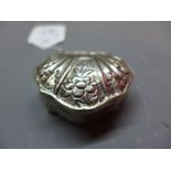 A 19th Century Dutch silver pill box with floral decoration.
