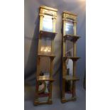 A pair of neo-classical style hanging shelves with mirrored backs.