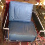 A pair of Le Corbusier style Cassina arm chairs with blue leather cushions and chrome supports.