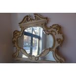 A 19th Century French white painted and parcel gilt over mantle mirror with bevelled glass plates,