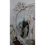 A large 19th Century style white painted and parcel gilded mirror with oval plate having floral