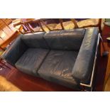 A Le Corbusier style Cassina three seater sofa with blue leather cushions and chrome supports.