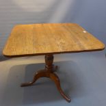 An oak tilt top table.