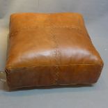 A contemporary brown leather pouffe