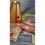 A collection of vintage games including a Ouija board, spirograph and various other games and toys.