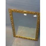 A 20th Century giltwood mirror with bevelled glass plate