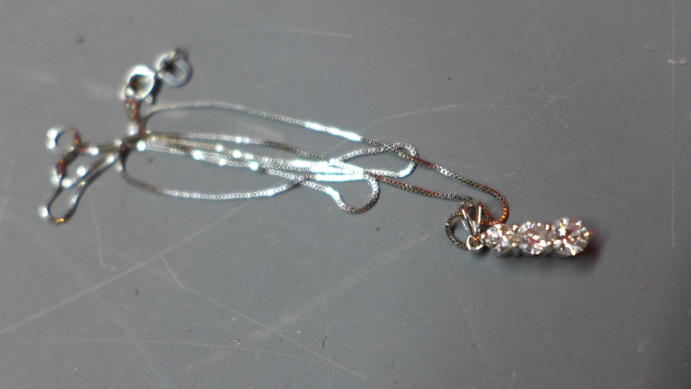 A ladies 18ct white gold necklace, having three diamond drop pendant. Marked 750.