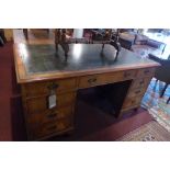 A Georgian style walnut pedestal desk having an arrangement of nine drawers,