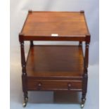 A mahogany side table with single drawer with castors